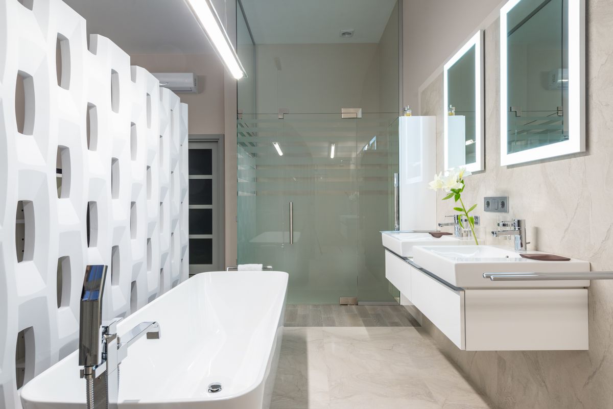 Bright bathroom with a glass shower enclosure and tub