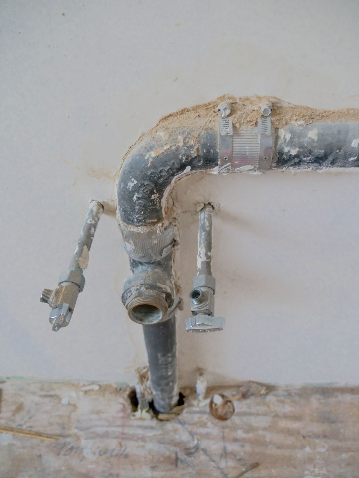 Exterior wall pipework and an outdoor spigot
