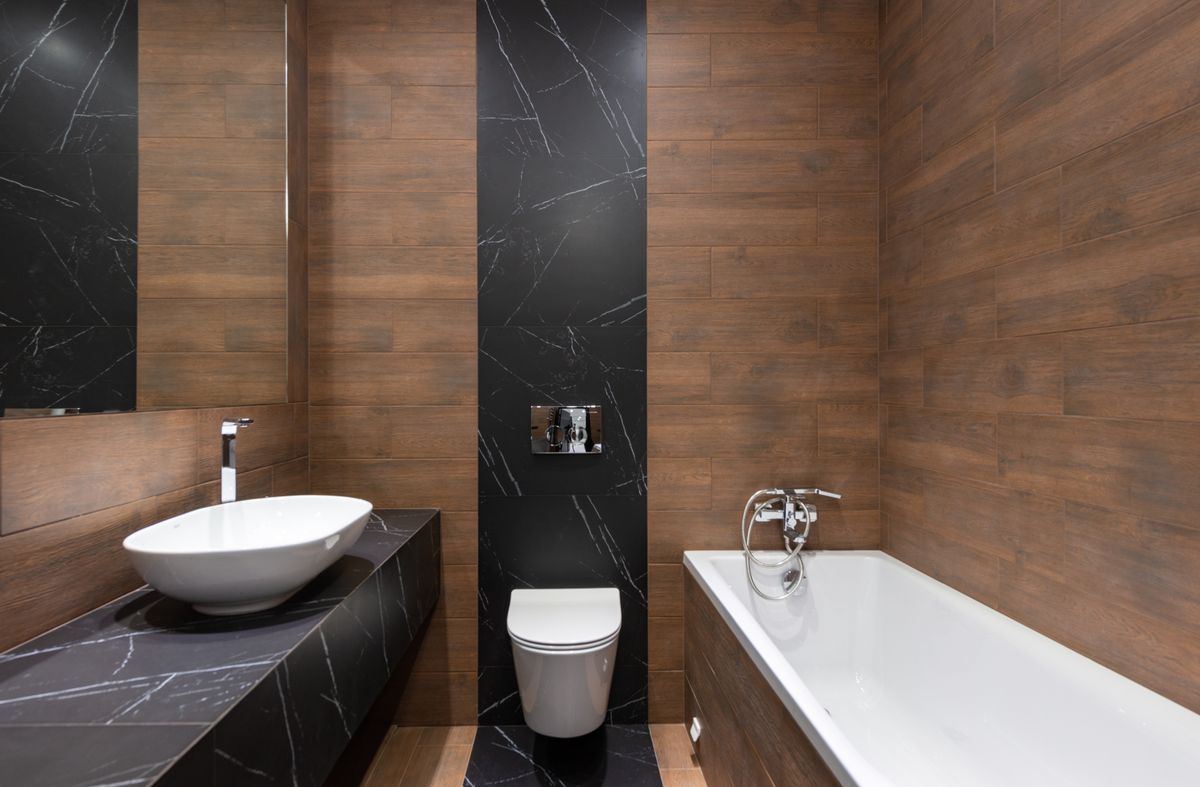 Modern bathroom with a wall-hung toilet and dark marble tile
